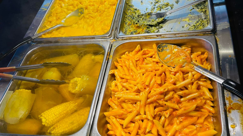 Four buffet trays with pasta and corn at Royal Hibachi Buffet
