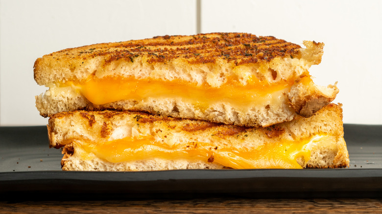 grilled cheese sandwich on a black tray