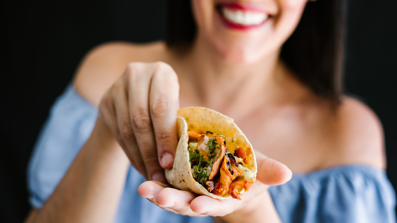 Woman holding a taco