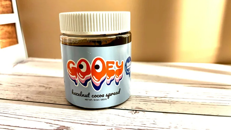 Gooey Hazelnut Cocoa Spread in jar on a wooden table