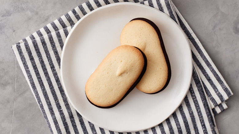 Milano cookies on white plate on striped napkin