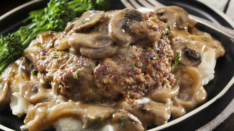Salisbury steak with mushroom gravy, served over mashed potatoes