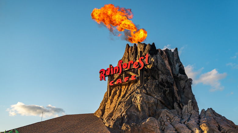 Rainforest Cafe volcano erupts against blue sky