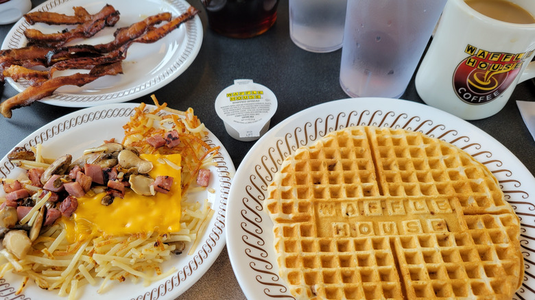 Waffles, topped hashbrowns, bacon, and coffee at Waffle House