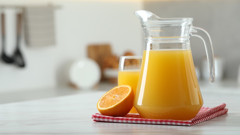 pitcher of orange juice on counter