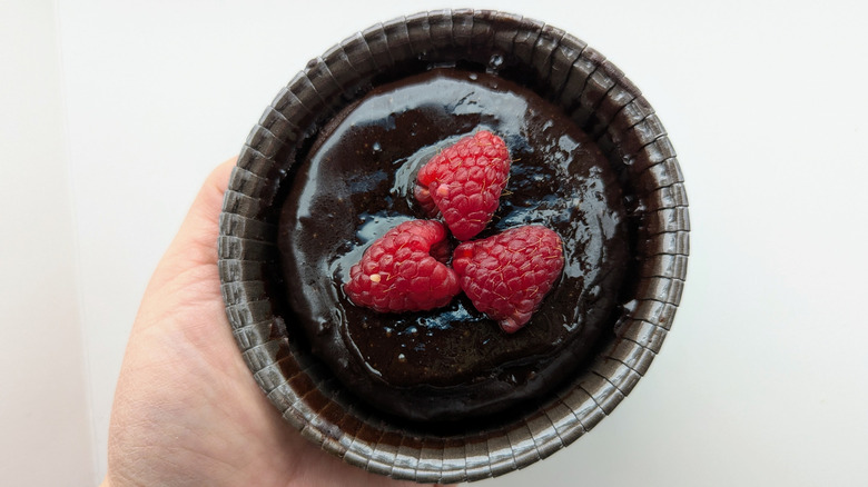 hand holding flourless chocolate cake