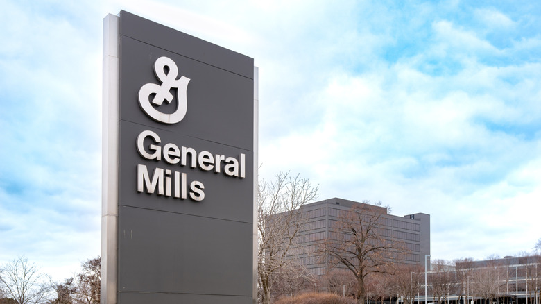 Exterior of General Mills' corporate offices focused on sign in front of low-rise office buildings