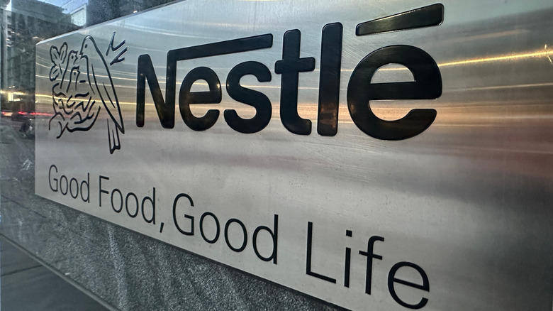 Metallic Nestlé brand sign in front of company headquarters