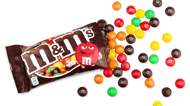An open bag of M&M's with the candy spilling out