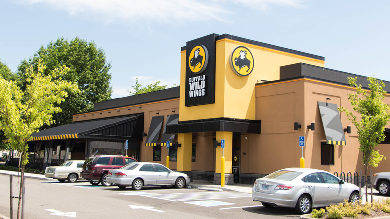 Exterior of a Buffalo Wild Wings restaurant with multiple cars in the parking lot
