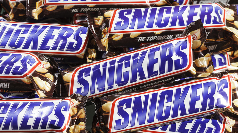 Snickers candy bars piled up together