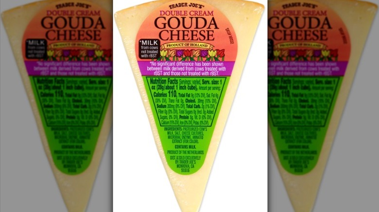 A wedge of Trader Joe's Double Cream Gouda Cheese on a white background.