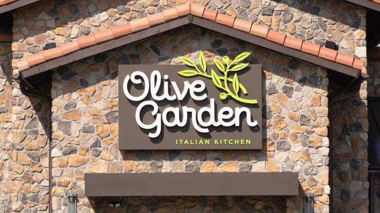 The exterior of an Olive Garden with the sign.