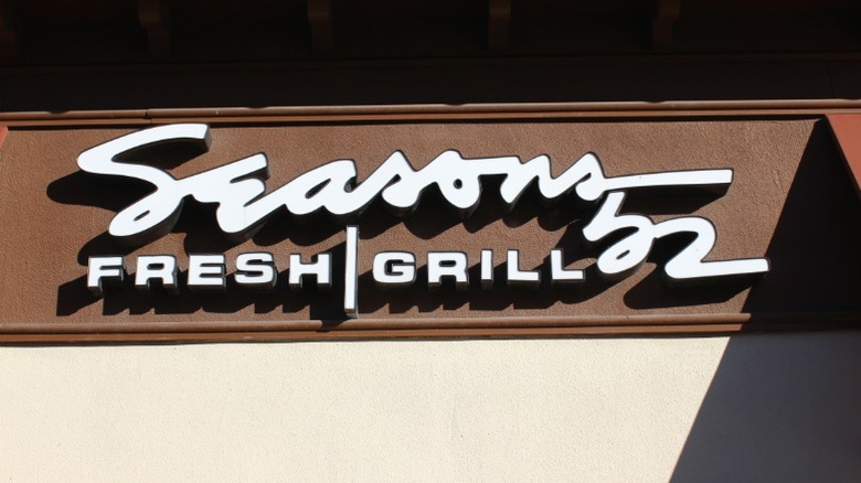 The logo for Seasons 52 on the side of a wall.