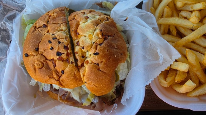 Cajun Roast Beef on onion roll with side of French fries from Frisco Deli