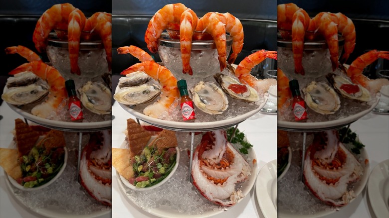Seafood platter with oysters, shrimp, and lobster on ice