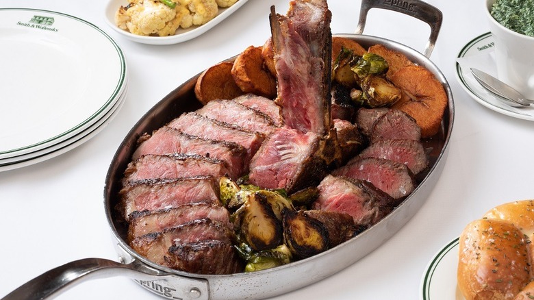 Wagyu porterhouse sliced and served on a metal platter
