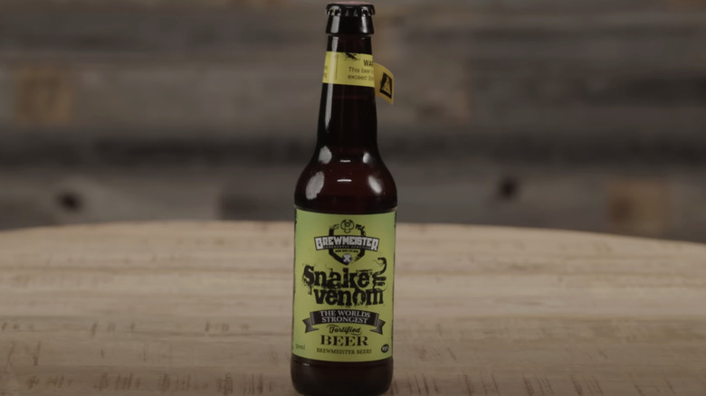 Bottle of Snake Venom beer with a yellow warning label affixed to the neck of the bottle.
