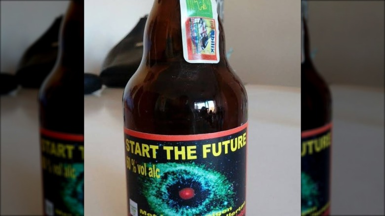 One bottle of start the future beer in dark bottle with galaxy on label