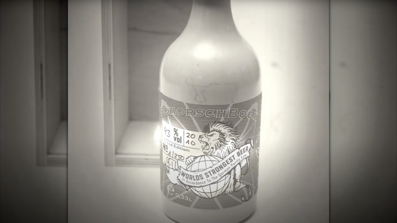 Bottle of Schorschbock 43 in front of wooden case with black and white filter