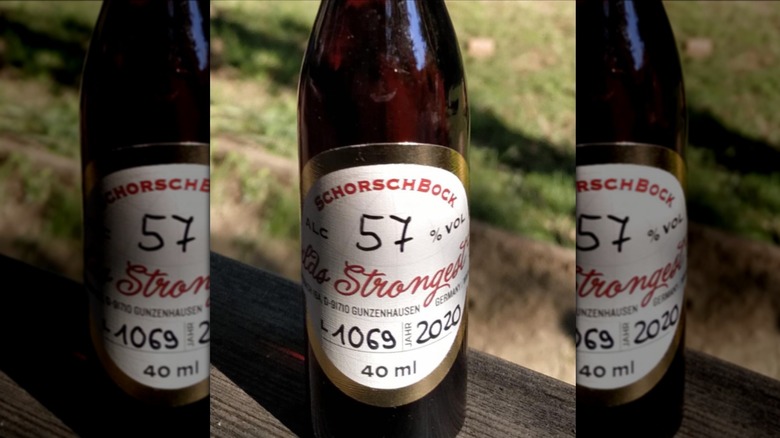Schorschbock 57 in dark amber beer bottle on picnic table outside