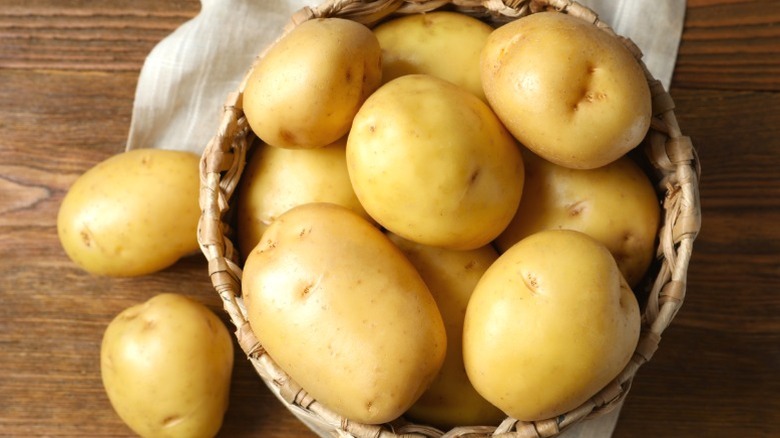 Whole young raw potatoes in a basket