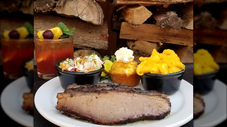 Sliced Brisket alongside coleslaw, mac and cheese, and a bread muffin from Double B's BBQ