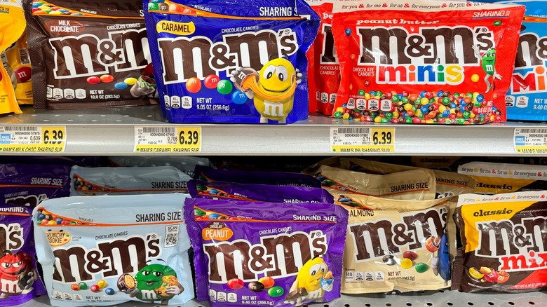 Various M&M flavors on a store shelf.