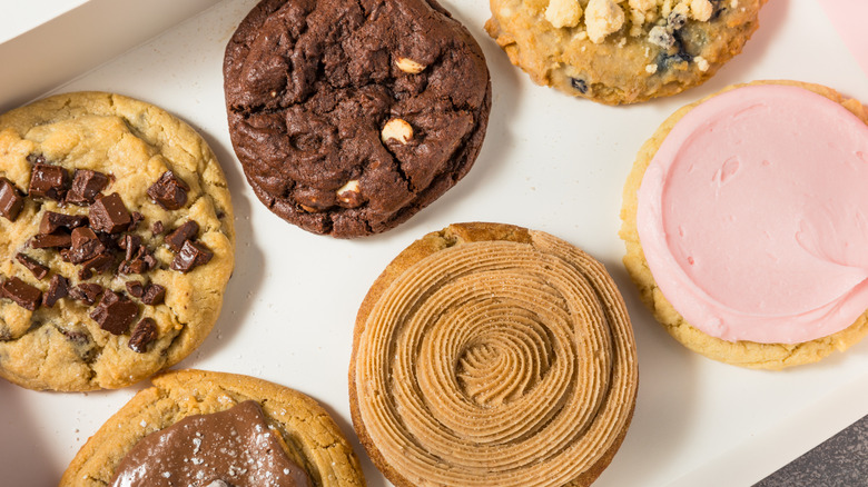 Six different Crumbl cookies in a box