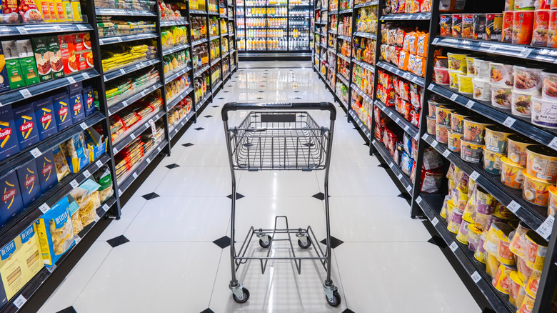 Shopping cart surrounded by groceries