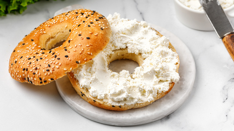 A bagel with cream cheese on a plate
