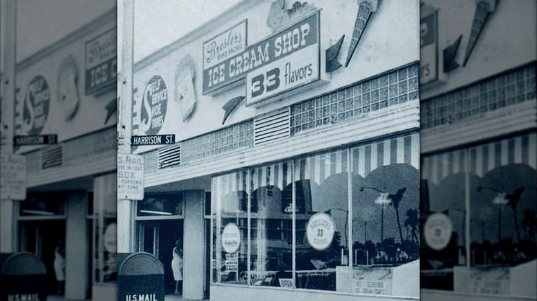 Black-and-white exterior photo of Bresler's Ice Cream Shop, with a sign boasting 33 flavors among whimsical ice cream decorations.