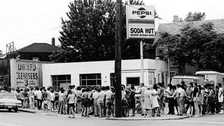 A crowd of people lines up around a block to get a taste of Steve's Ice Cream.