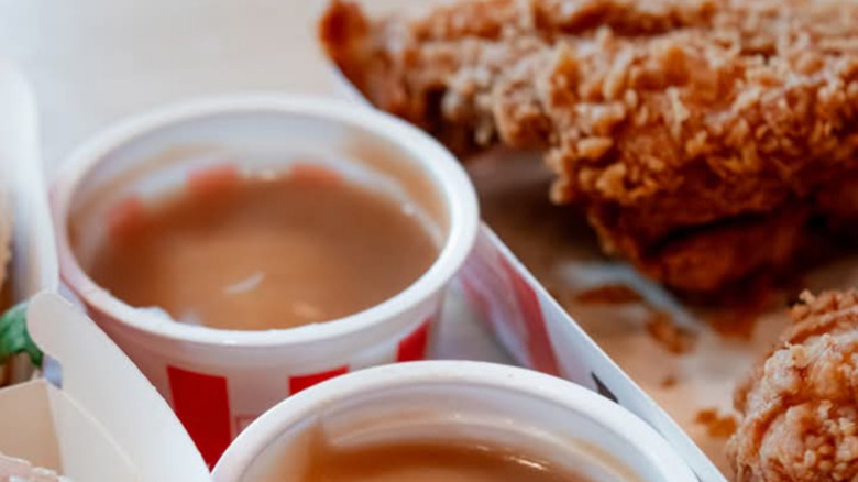 KFC mashed potatoes with gravy next to fried chicken