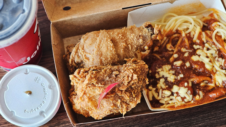 A perfect pair order from Jollibee containing two pieces of fried chicken and spaghetti in the package