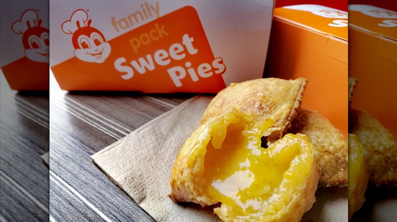 A peach mango pie broken open on a napkin.