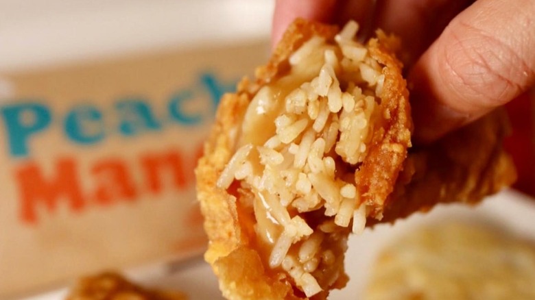 A chicken skin peeled from a piece of Jollibee chicken with rice and gravy wrapped inside of it.