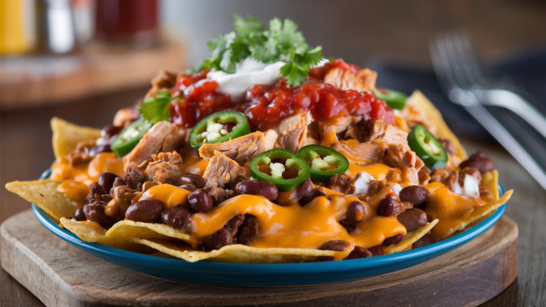 Loaded Tex-Mex-style nachos on blue plate