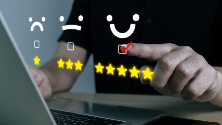 Reviews hover over laptop as person leaves five stars