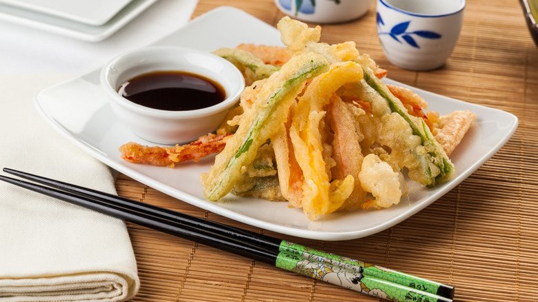 Tempura platter of veggies and fish with soy sauce on side