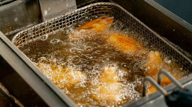 Golden brown food in a bubbling deep fryer