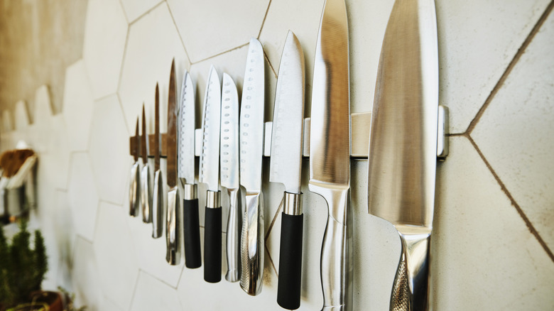 Close-up shot of a set of knives hung on a wall