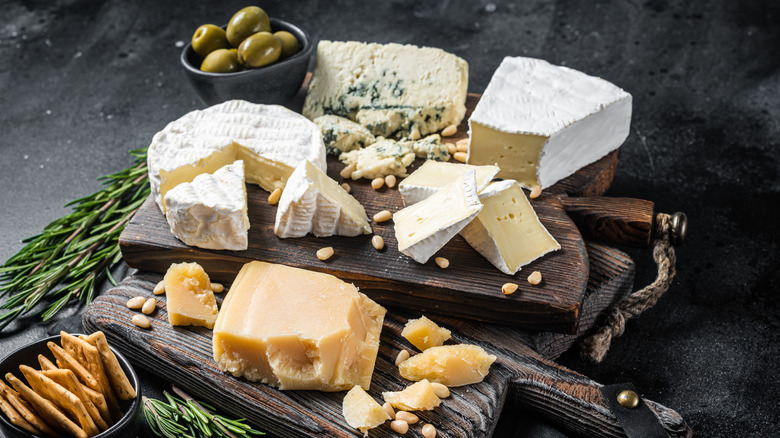 cheese plate with olives, herbs, and crackers
