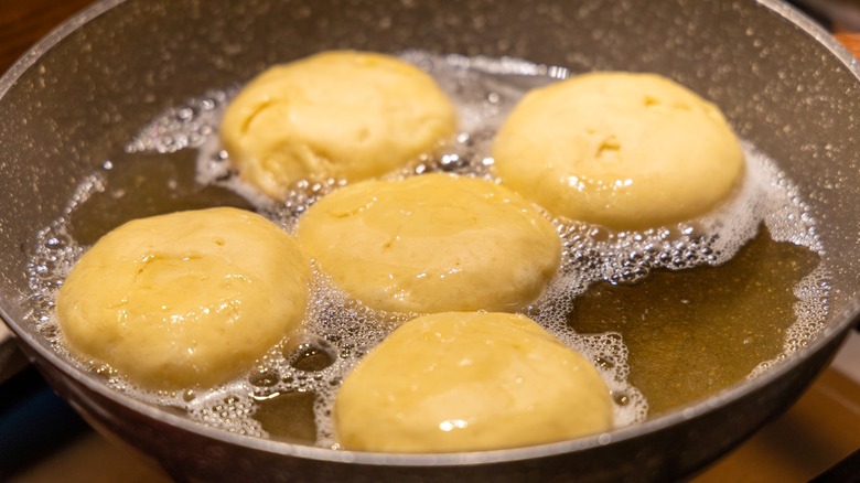 Donuts frying in hot oil