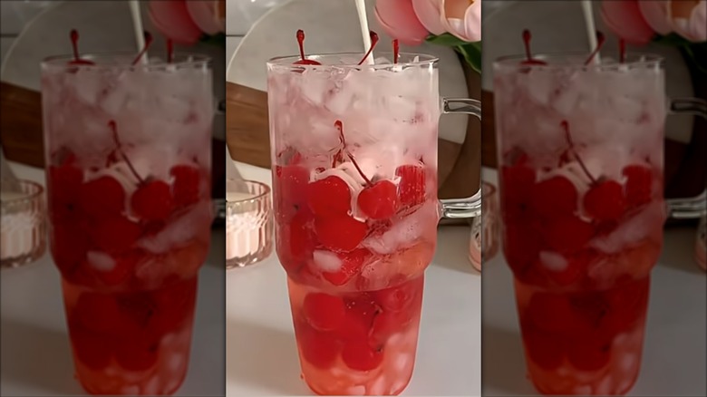 Cream pouring into a Dirty Cherry Sprite with Ice and cherries in the glass