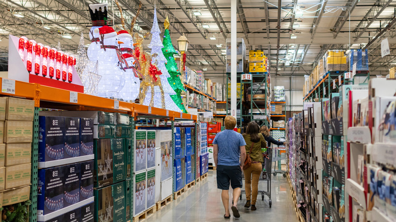 Shoppers walking by Christmas decorations at Costco