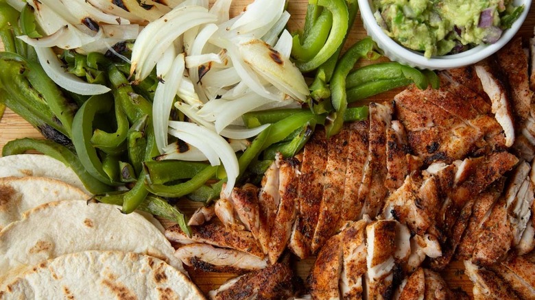 grilled chicken and vegetables with guacamole and flour tortillas