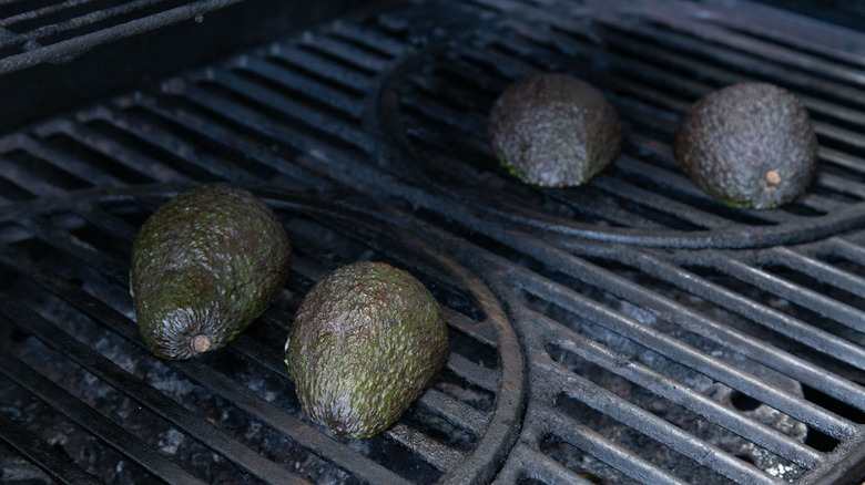 avocado halves on a grill
