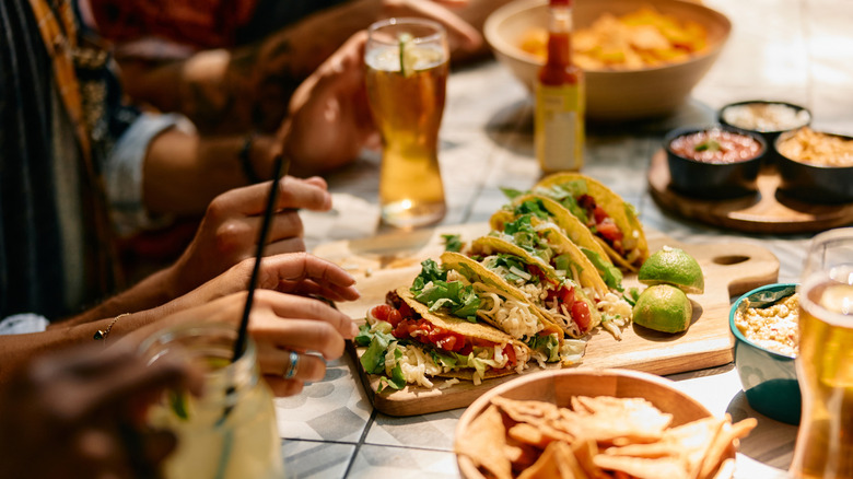 Tacos, chips, and beer on a table at a Mexican restaurant