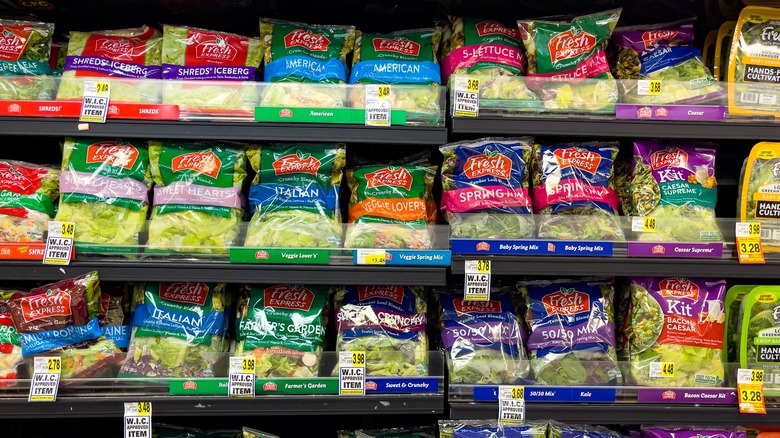 rows of bagged salad in a grocery store